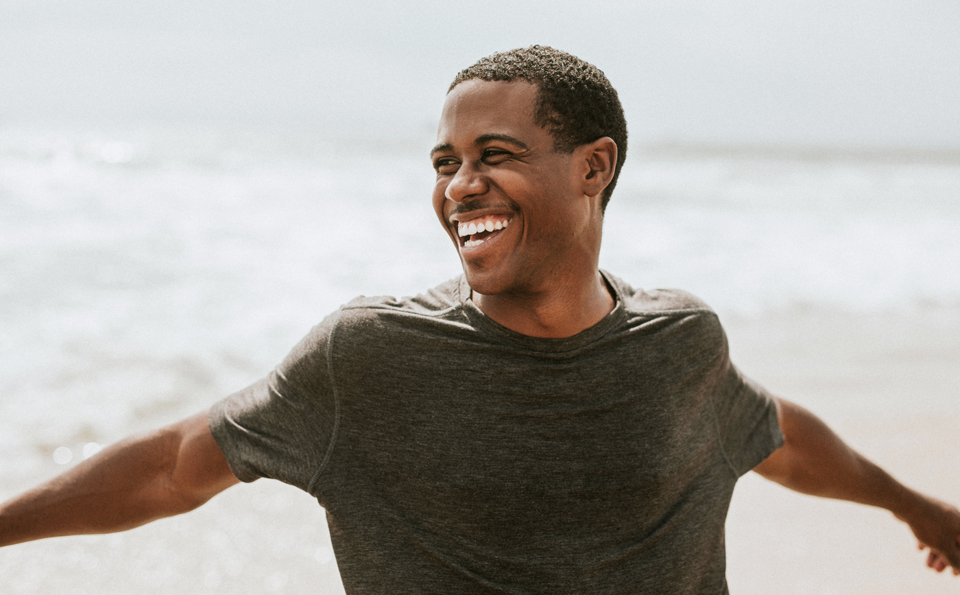 Man smiling after oral surgery in Seminole FL