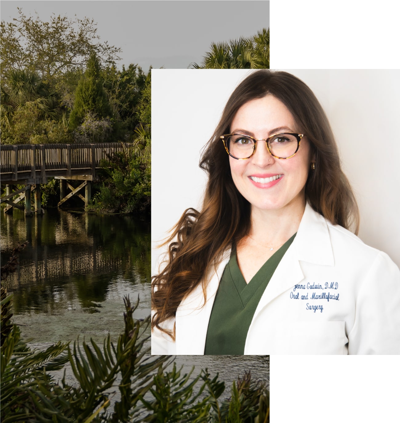 Smiling woman in glasses and white coat over green top, with nature background.