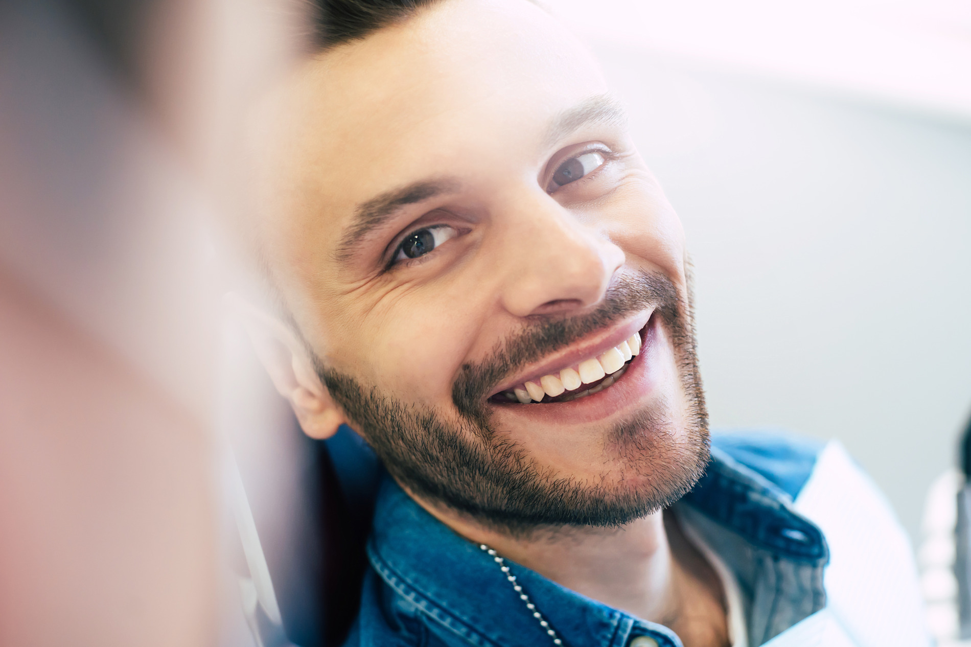 Man smiling after a wisdom tooth extraction in Seminole FL