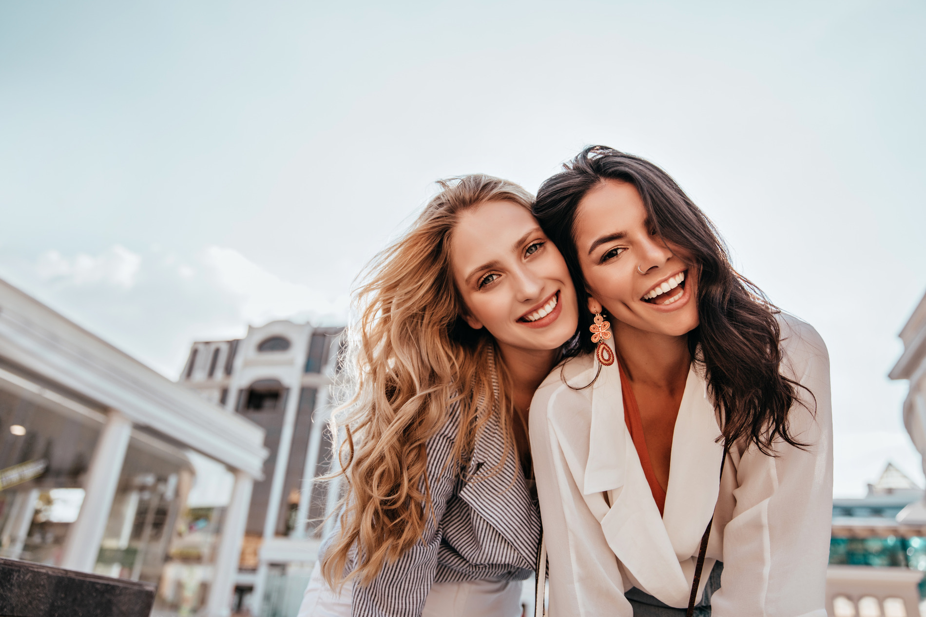 Women smiling and hugging after a successful wisdom tooth extraction in Seminole FL