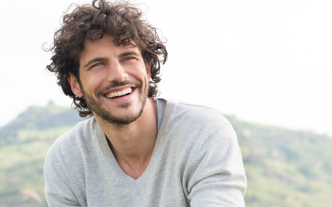 Man smiling confidently, representing successful recovery from oral surgery in Seminole FL